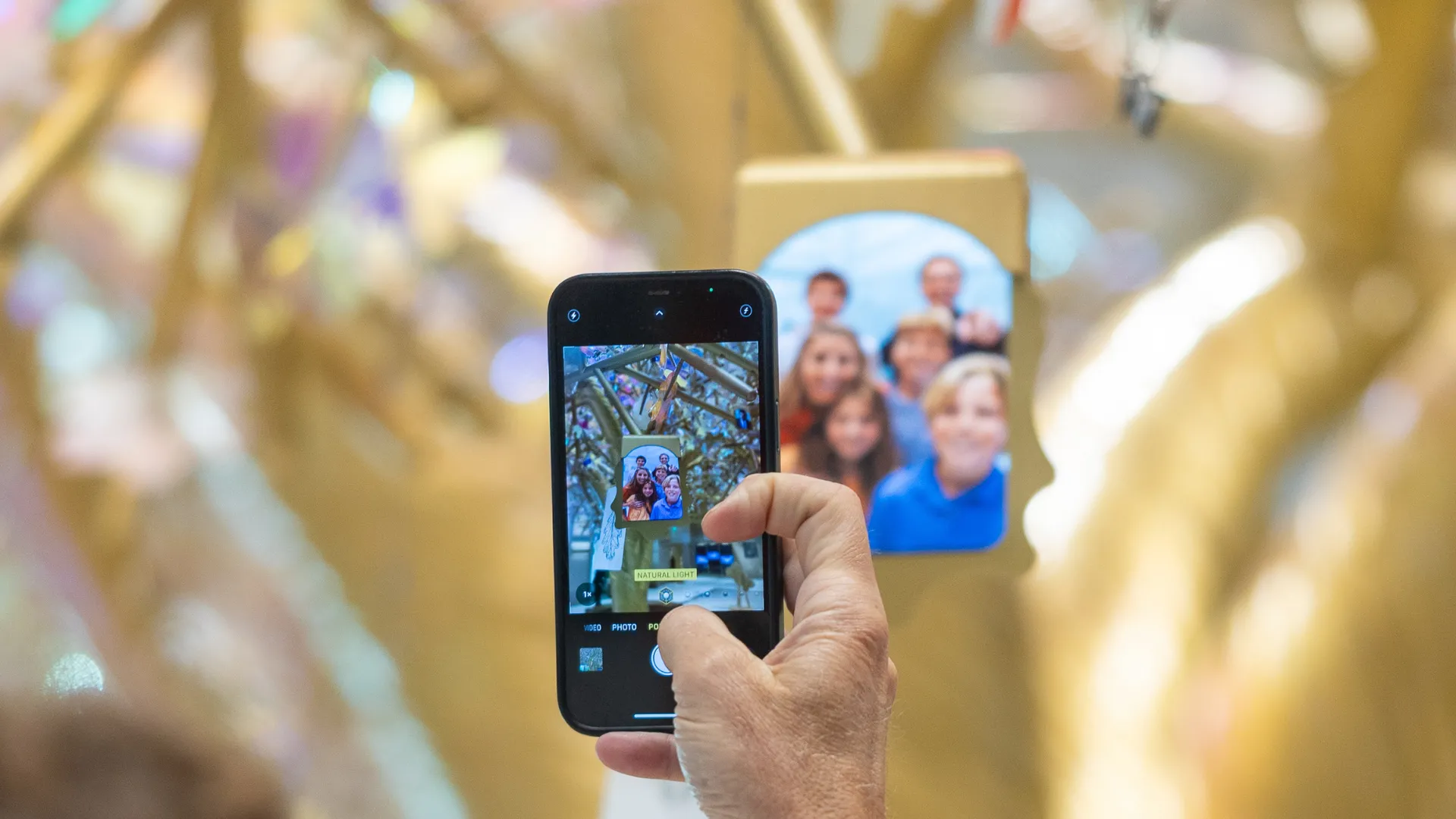 A visitor photographs their submission to the Tree.